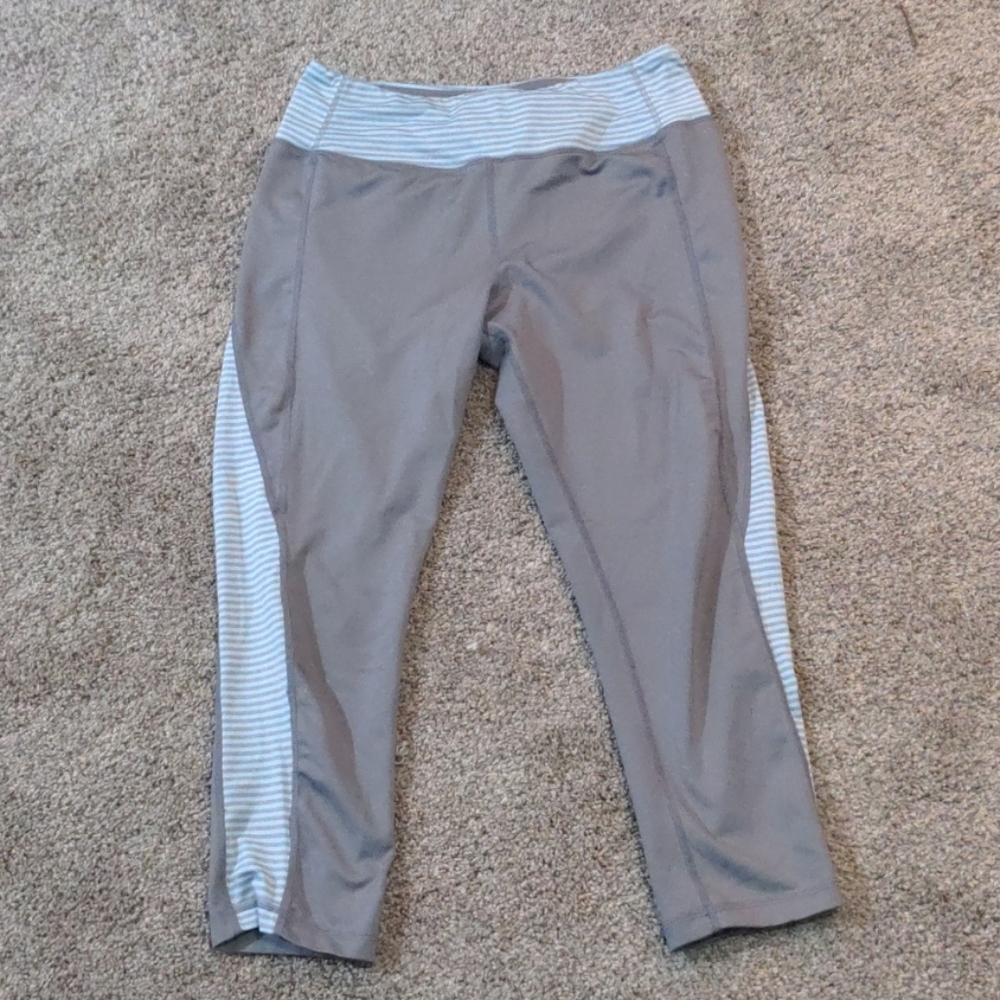 Light grey leggings, blue and grey strips on side
